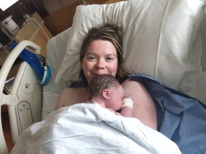 picture of shawna holder her newborn in the hospital bed.