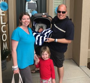 Shawna, Ryan and 3-year-old Cambryn Purvis on the porch of their home with newborn Kyler in the car seat.