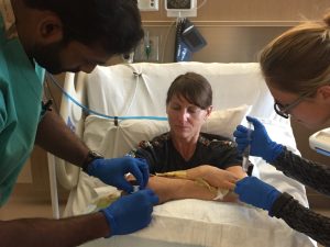 Melissa Strong, arms crossed in the I Dream of Jeanie position, receives care from providers at UCH