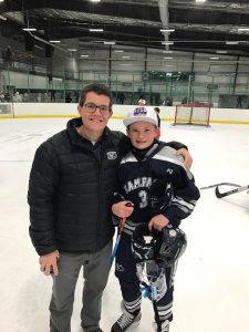 Leland Fay is pictured at a hockey rink with one of his sons.