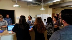A student director of the DAWN Clinic speaks to a large group of volunteers.