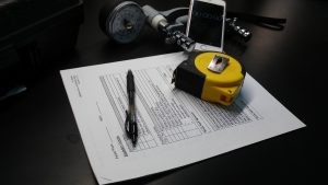 A few of the simple tools needed for a frailty assessment: grip measurement instrument, a tape measure for walking speed, a smartphone (which plays the role of a stopwatch in recording walking time), a consent form and a pen for filling it out. The data gleaned from these low-tech items could yield powerful data in predicting surgical outcomes for patients with brain tumors.