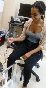 ahwa Netsanet, clinical trial coordinator with the CU Orthopedic Spine Division, demonstrates the pain-measurement device.