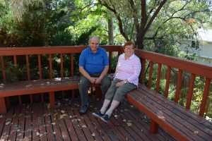 Dina and Leon Altschul sit outside on their deck.