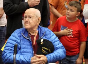 WWII Pfc. Jim Ingram and his grandson listen to the National Anthem during the Honor Flight Northern Colorado send-off celebration on Sept. 17, 2017 at Embassy Suites in Loveland.
