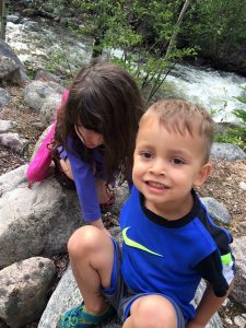 Daniell's son plays on rocks with his girl cousin.