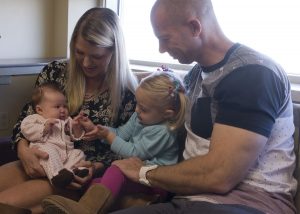Melissa and Sean Keel look on as Cali, 2, works a high-five with her two-month-old sister Harper. Melissa and Harper were there for the first of six visits she and Harper will make to UCHealth University of Colorado Hospital during Harpers first year, as a part of a major diet study for women with gestational diabetes.
