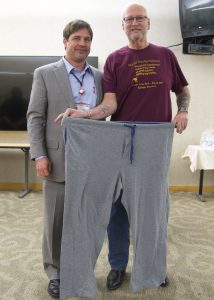 ennis Lawson, right, with the pants he wore the day of his bariatric surgery a year before. Jonathan Schoen, MD, left, performed it.