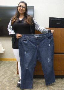 Misty Garcia holding a plus-size jean