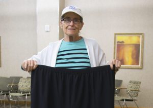 Jeanie Roe holding large stretch pants she use to wear.
