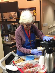 In this photo, Joan Gibbs, known as "the Cookie Lady," pours coffee.