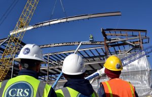 In this photo, construction crews watch as one of the highest beams of the UCHealth Greeley Hospital is raised.