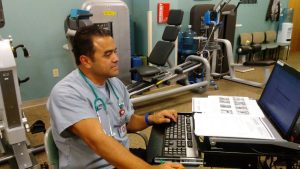 Respiratory therapist Hector Grajeda monitors patients' exercise in this photo.