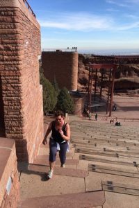 Gail Sadler is picutred running up the stairs at Red Rocks Amphitheater.
