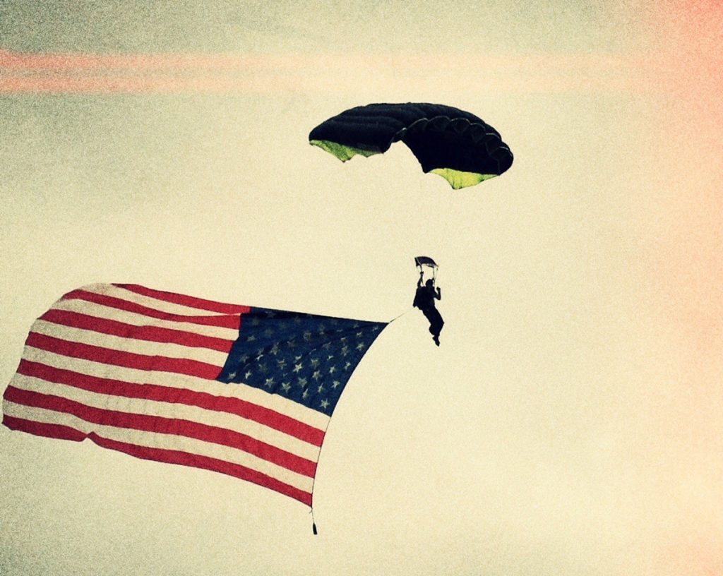 Jeff Bramsted, an organ donor for a liver transplant, skydives with an American flag.