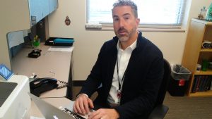 Dr. Aryeh Fischer, a UCHealth rheumatologist, sits at his desk.