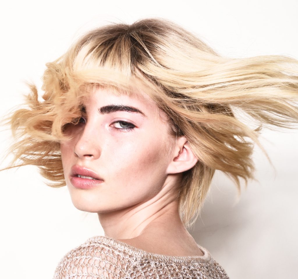 Peyton Linafelter who dealt with teen cancer, swings her hair in a modeling photo.