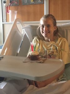 Peyton in the hospital with a birthday cupcake. She learned she had Stage IV ovarian cancer on her 16th birthday. Photo courtesy of Tera Gharrity.