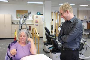 Dr. Patrick Johnston observes Barb Wheeler's progress during a therapy appointment.