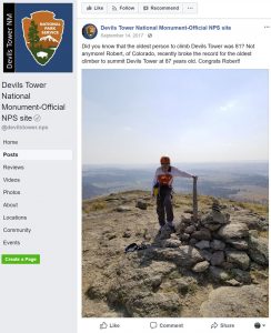 An image of a facebook post from the National Park Service featuring Robert Kelman at the top of Devils Tower.