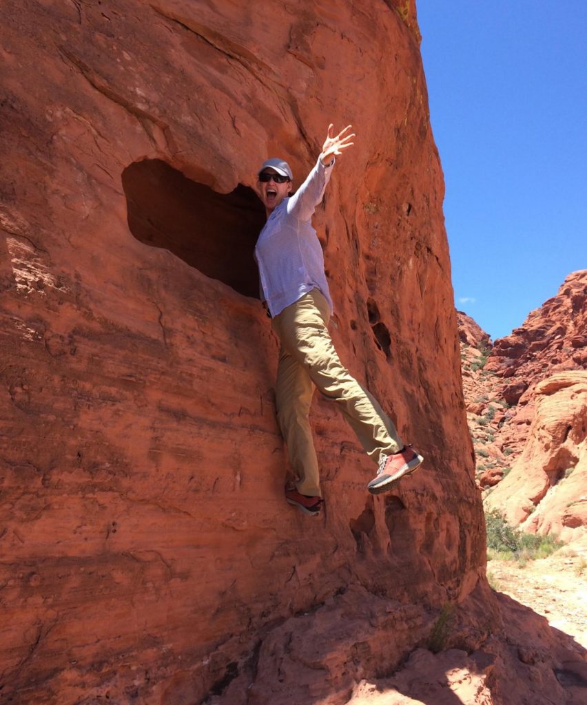 A full life with cancer. Dr. Ali Coffey decided to move to Colorado to live a more beautiful life after learning she had Stage IV lung cancer. Here she climbs a red rock.