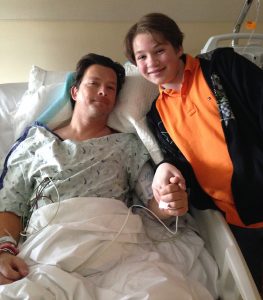 Patrick Gaines with his young son in the hospital after he had to have surgery for a spinal tumor. When Patrick was using alcohol and marijuana, his son told him he had to stop.