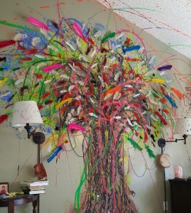 A giant tree made of art sprouts on a wall at Patrick Gaines' house. He uses art along with other alternatives to opioids to deal with chronic pain.