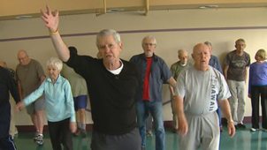 Movement as medicine for Parkinson's. Here, a man leads an exercise class for pepole with Parkinson's.