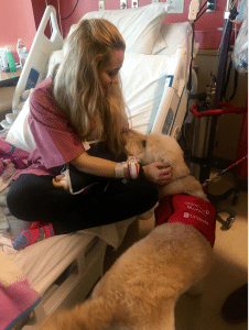 London Lyle is comforted by a therapy dog named Murphy.
