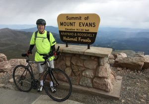 David Brenner on top of Colorado's Mount Evans with his bike, during which time he was battling coronary artery disease..