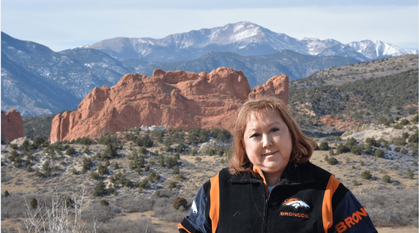 Linda Regis is pictured in front of Kissing Camels at the Garden of the Gods, with Pikes Peak in the background