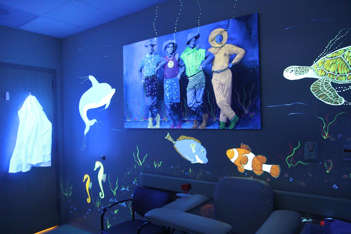 black light art on the walls of a lab room.