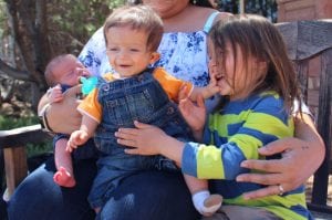 Brothers Parker, Owen and Wyatt are pictured on their mother's lap.