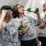 A cancer survivor laughs as she sprays sparkling cider all over in celebration of hitting another milestone.