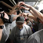 Cancer survivors walk beneath a human tunnel on their way into the Colorado Eagles' locker room.