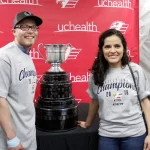 A couple poses for a photo with the Kelly Cup.