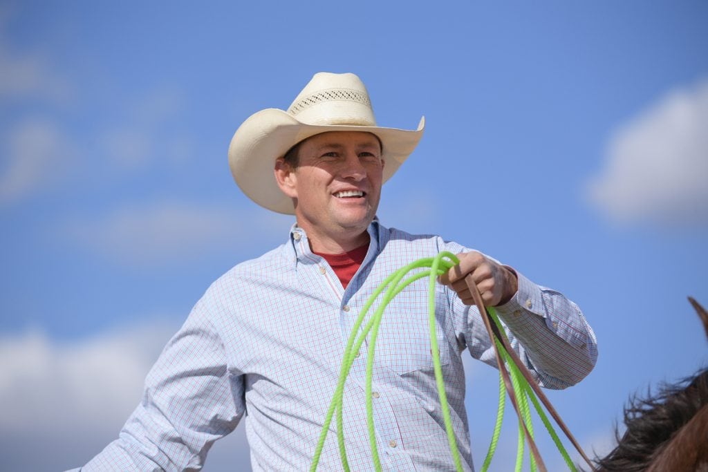 Archie Chant holds his green rope as he sits on his horse. He's wearing a cowboy hat. Thanks to the help he got after a terrible car accident, Archie is riding, roping and ranching again.