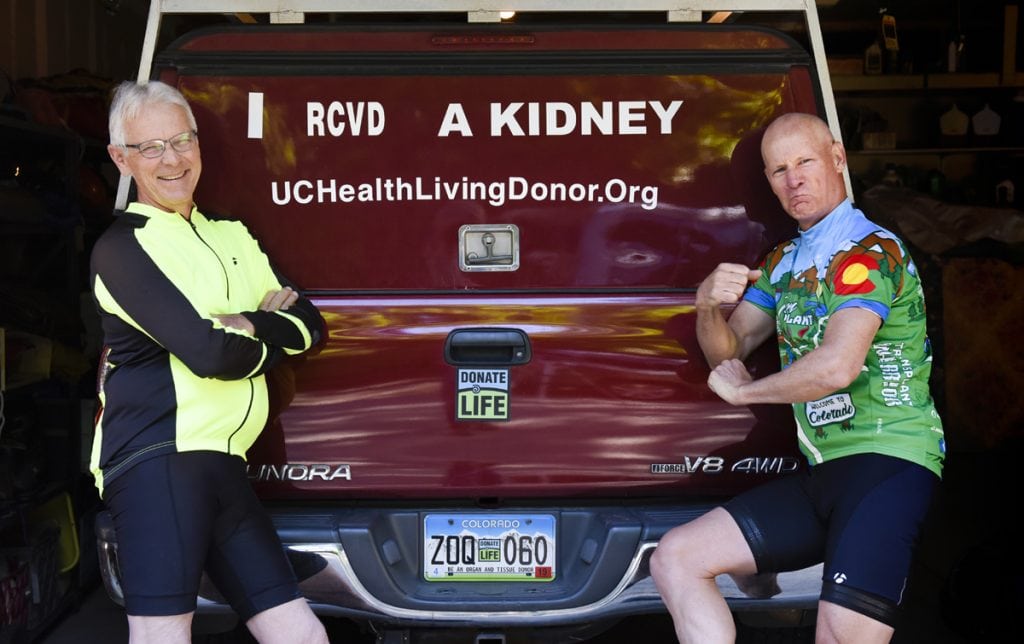 Jim Eastman, left, and Scott La Point get together for a bike ride at Eastman's home in Niwot, CO. La Point donated one of his kidneys to Eastman and the two of them will be competing at the upcoming Transplant Games in Salt Lake City. Eastman hams it up for the photo as they stood by Eastman's truck which used to advertise, "I Need a Kidney." Now it says, "I Received a Kidney." Photo by Cyrus McCrimmon for UCHealth.