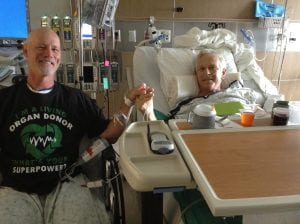 Scott La Point, left, holds Jim Eastman's hand in UCHealth University of Colorado Hospital after their transplant surgery last June. Photo courtesy of Scott La Point.