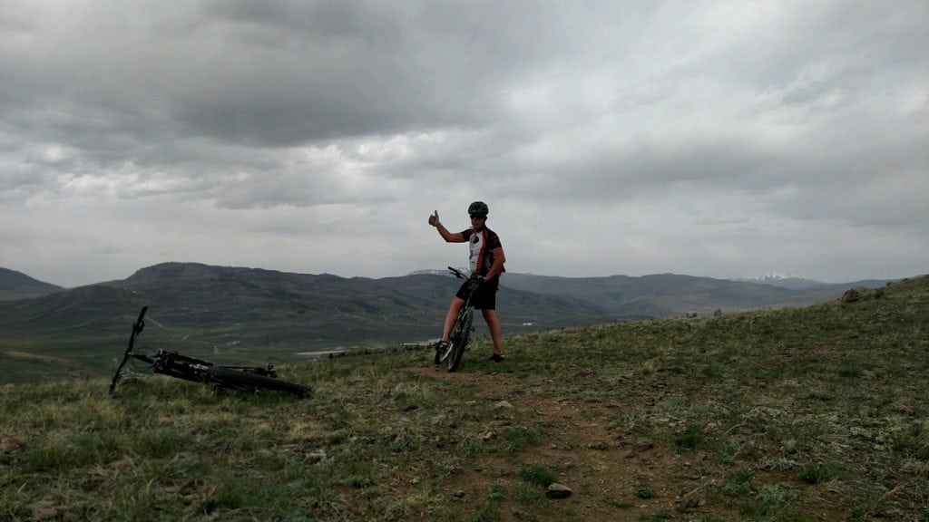 Cyclist Rich Trostel gives a thumbs up. He's on a mountain biking trail during his first ride after a partial knee replacement.