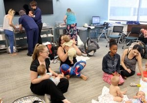 Activity at the breastfeeding support groups include moms nursing, weighting their babies and talking to lactation consultants.