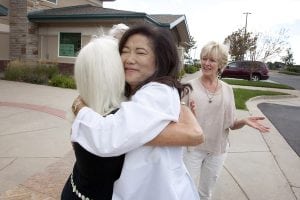 UCHealth internal medicine physician Dr. Cathy Ow embraces her patient of more than 20 years, Lane Oesterle-Miller outside her UCHealth Internal Medicine Snow Mesa office