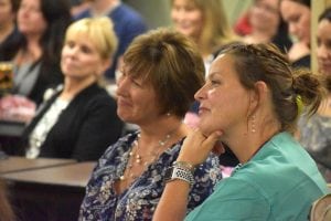 Two women smile proudly as they listen to remarks about Poudre Valley Hospital's latest recognition.