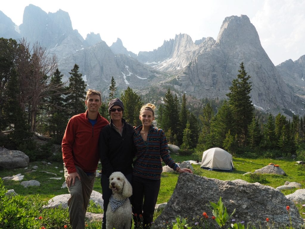 A photo of a family before a backdrop of jagged peaks in the Wind River Wilderness.