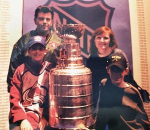 family standing with the Stanley cup