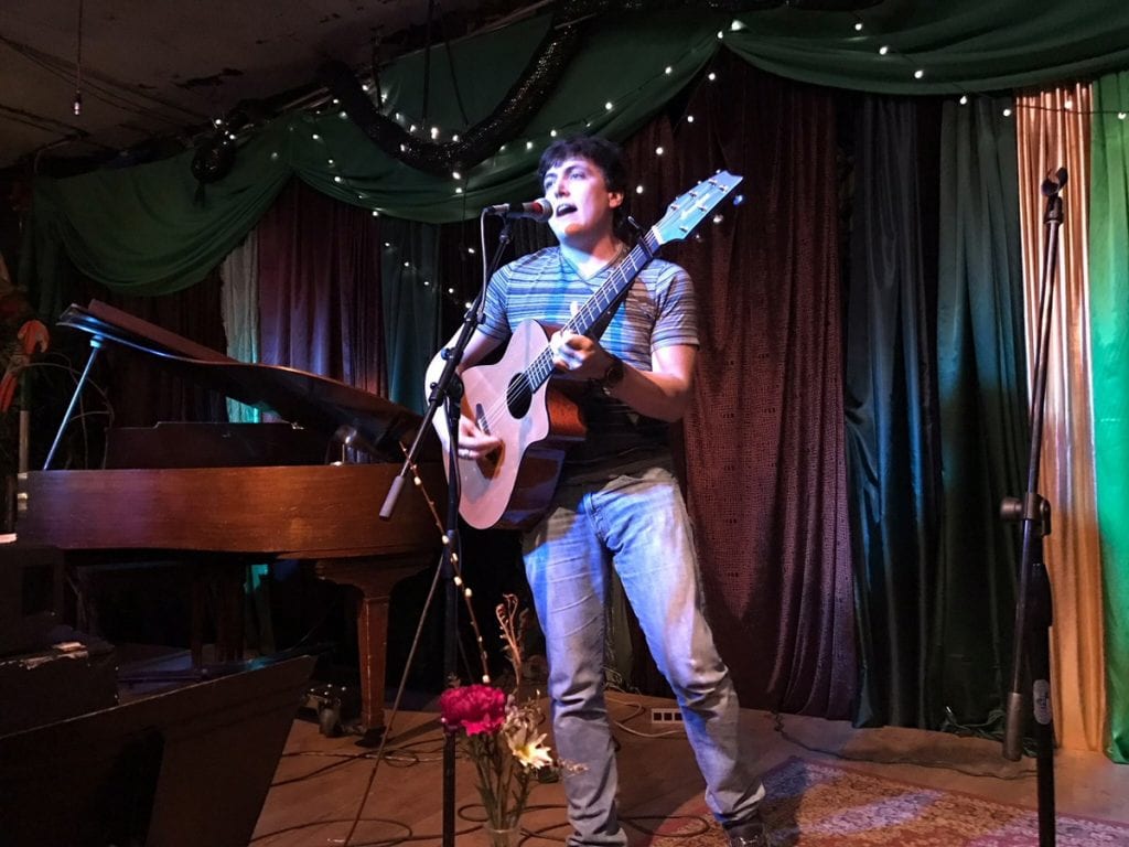 Daniel Schwartz playing guitar during an open mike night.