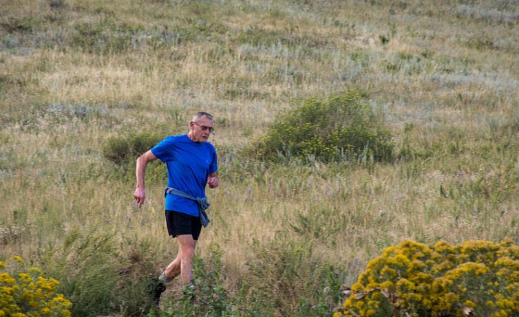 Val Tirman running along a trail in Colorado.