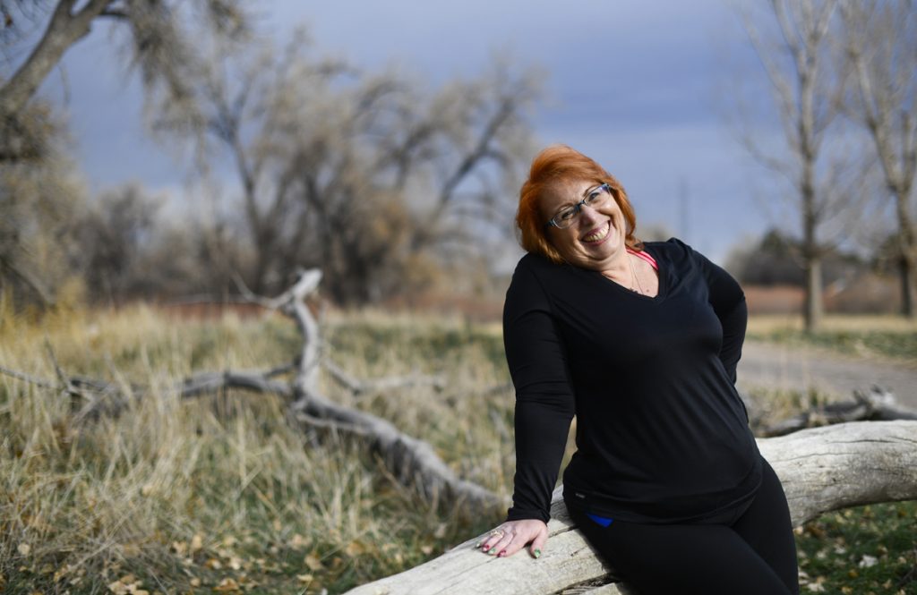 Linda Chandler has lost 70 pounds after knee surgery. She pauses during a run to show off her new slimmer figure.