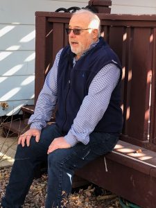 Bob Waddell sits on his deck in his back yard in Colorado Springs.