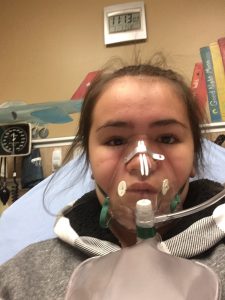 Mila Schreder, 11, wears an oxygen mask at the UCHealth Emergency Room - Smoky Hill. Mila, her brother Will, 14, and their parents all had to be treated for carbon monoxide poisoning after a faulty furnace filled their home with the deadly gas. Photo courtesy of Mila Schreder.